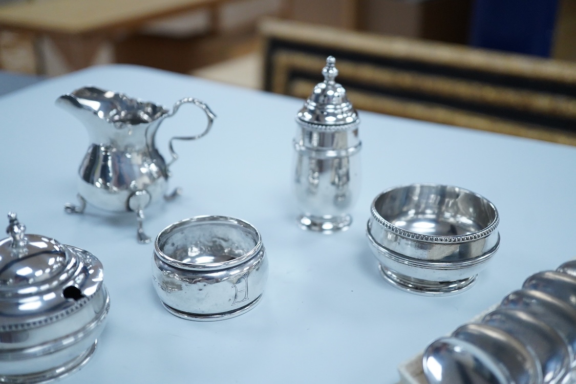 Small silver including a three piece cruet set, by George Howson, Sheffield, 1924/5/6, a napkin ring, a cream jug and a set of six 830s coffee spoons.